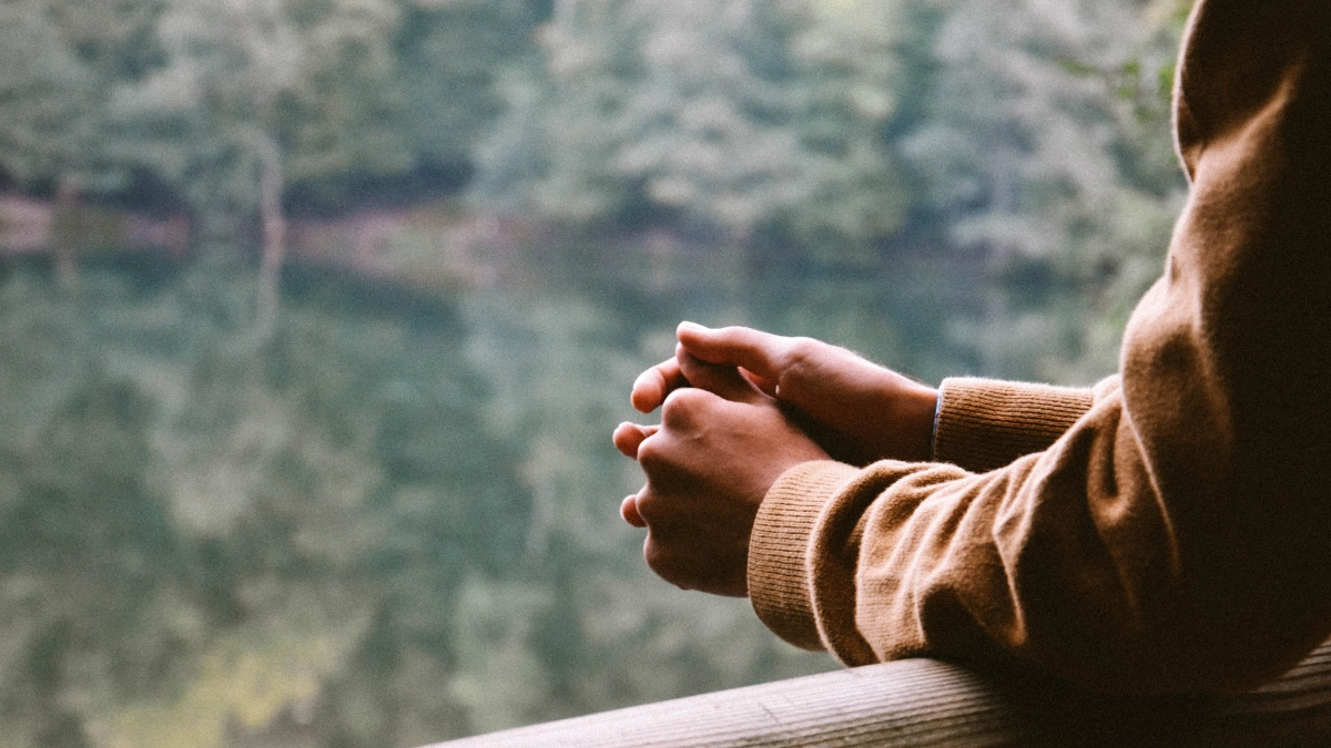 A person looking out from a balcony
